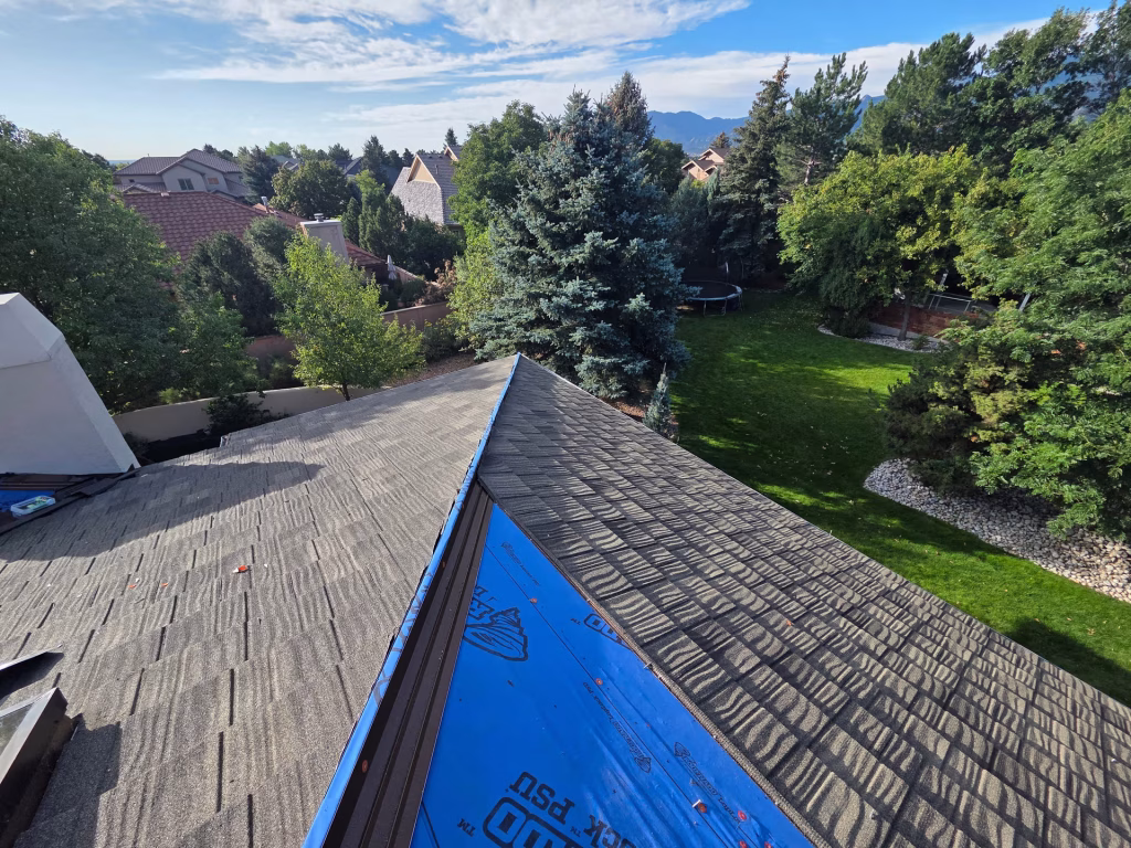 Roof ridge with underlayment exposed during installation.