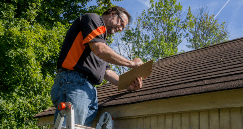 man inspecting roof